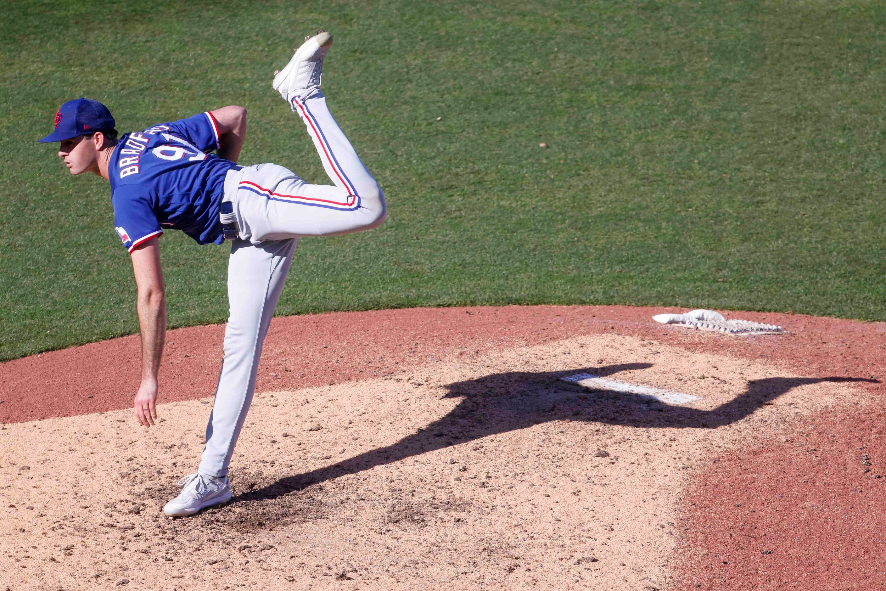 Texas Rangers Cody Bradford throws a pitch during the eighth inning of a spring training...