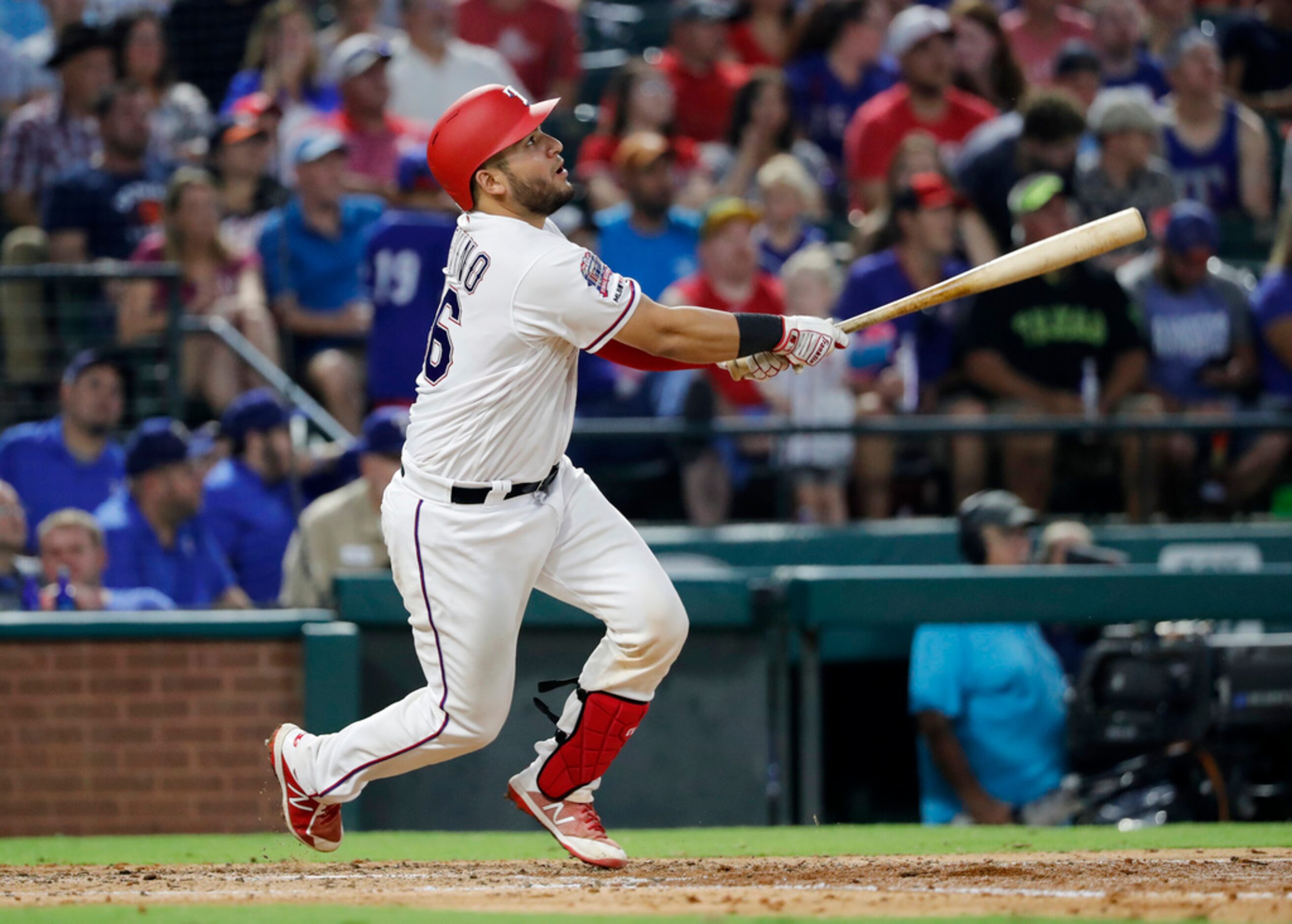 Texas Rangers' Jose Trevino follows through on a fly out to left in the fourth inning of a...