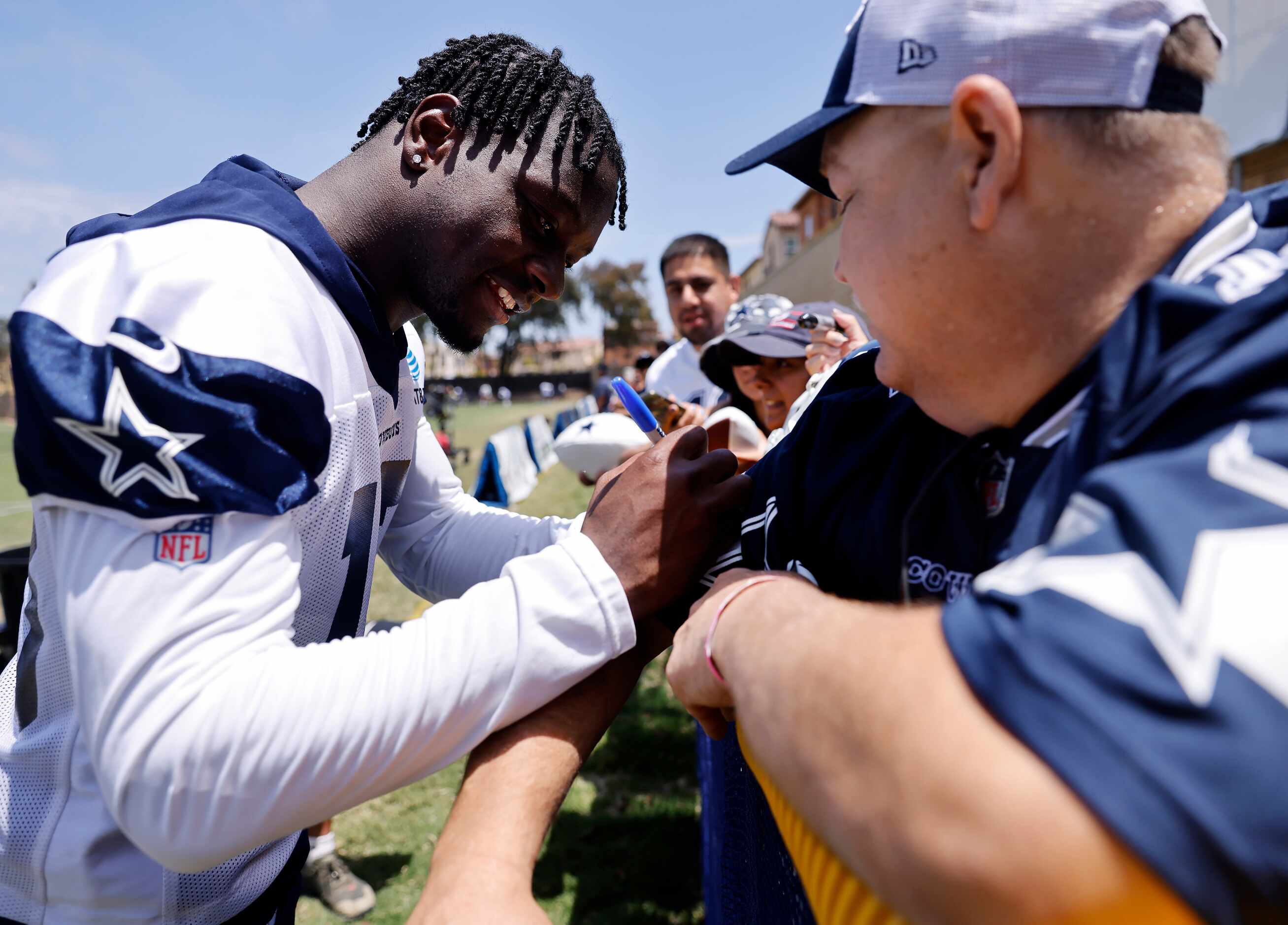 Injured Dallas Cowboys wide receiver Michael Gallup (13) signs autographs for fans following...