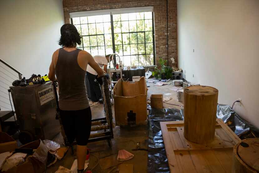 People help Simonett Pereira and Nils Johan Ekman move things out of their loft damaged by...