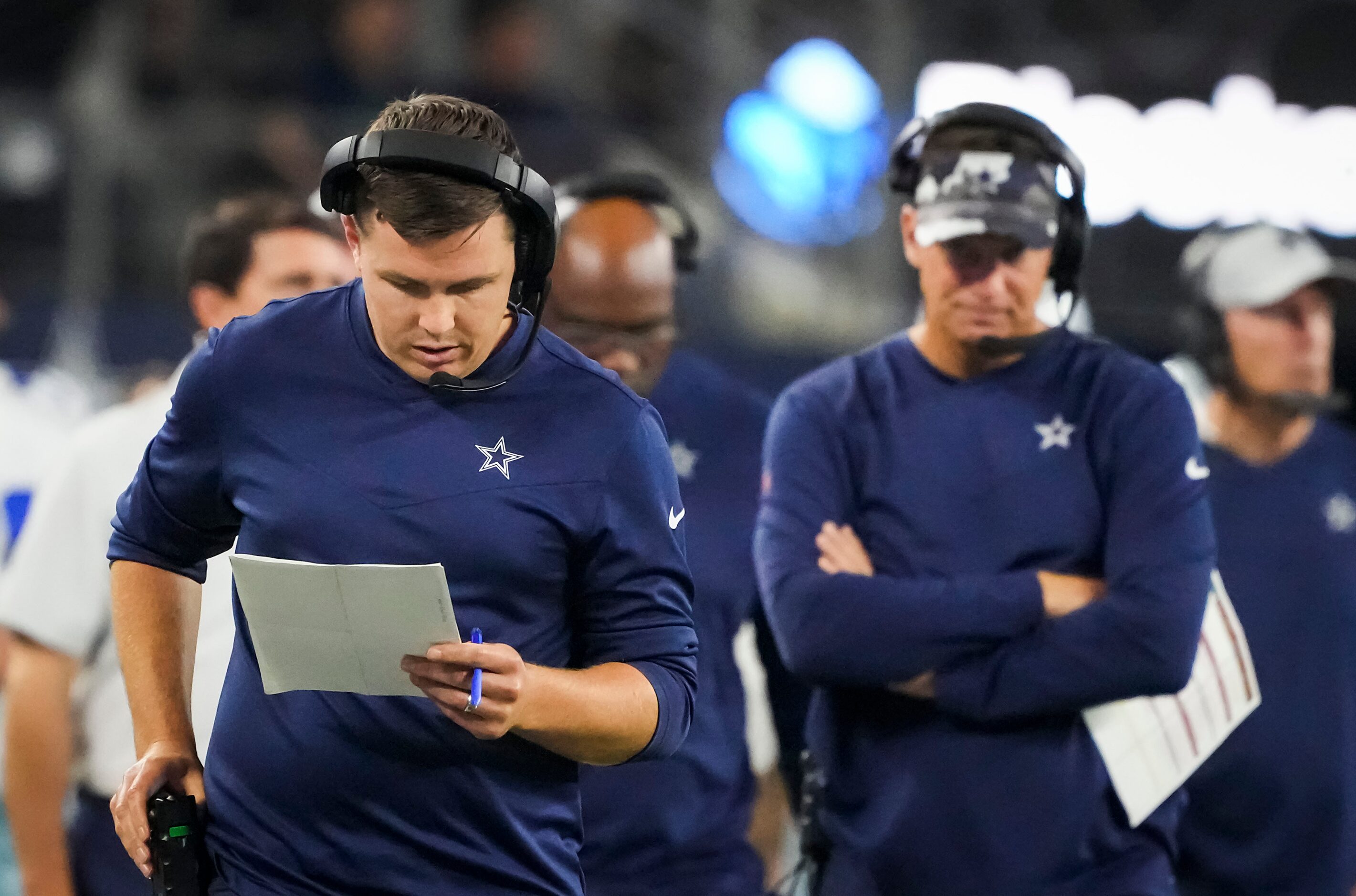 Dallas Cowboys offensive coordinator Kellen Moore works on the sidelines during the second...