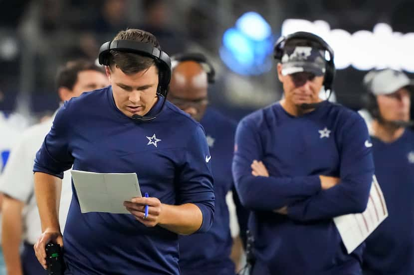 Dallas Cowboys offensive coordinator Kellen Moore works on the sidelines during the second...