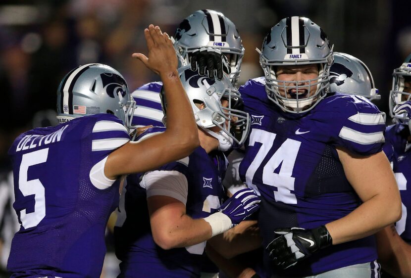 Kansas State quarterback Alex Delton (5) and offensive lineman Scott Frantz (74) celebrate a...