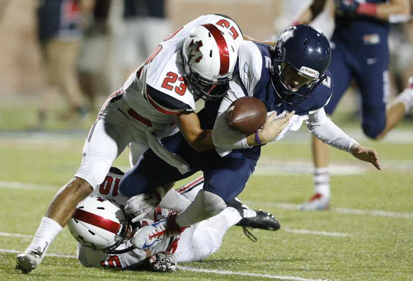 Allen Mitchell Jonke (2) looses control of the football as Flower Mound Marcus' Cameron...