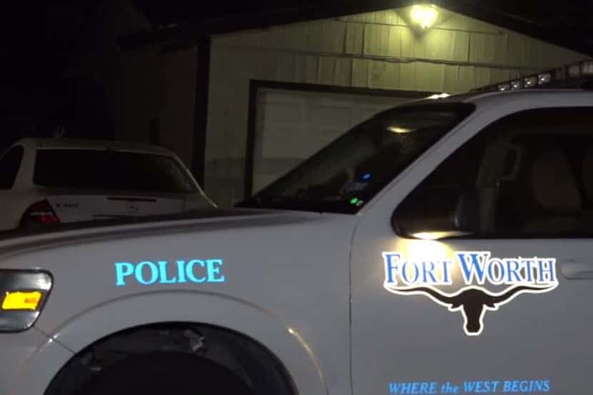 A Fort Worth police vehicle sits outside a home where a man was fatally shot Tuesday night.