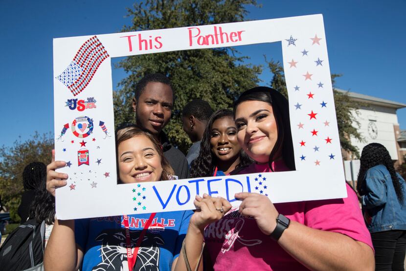 Duncanville High School students Stephannie Medina (front left) and Alazay Molina hold up a...