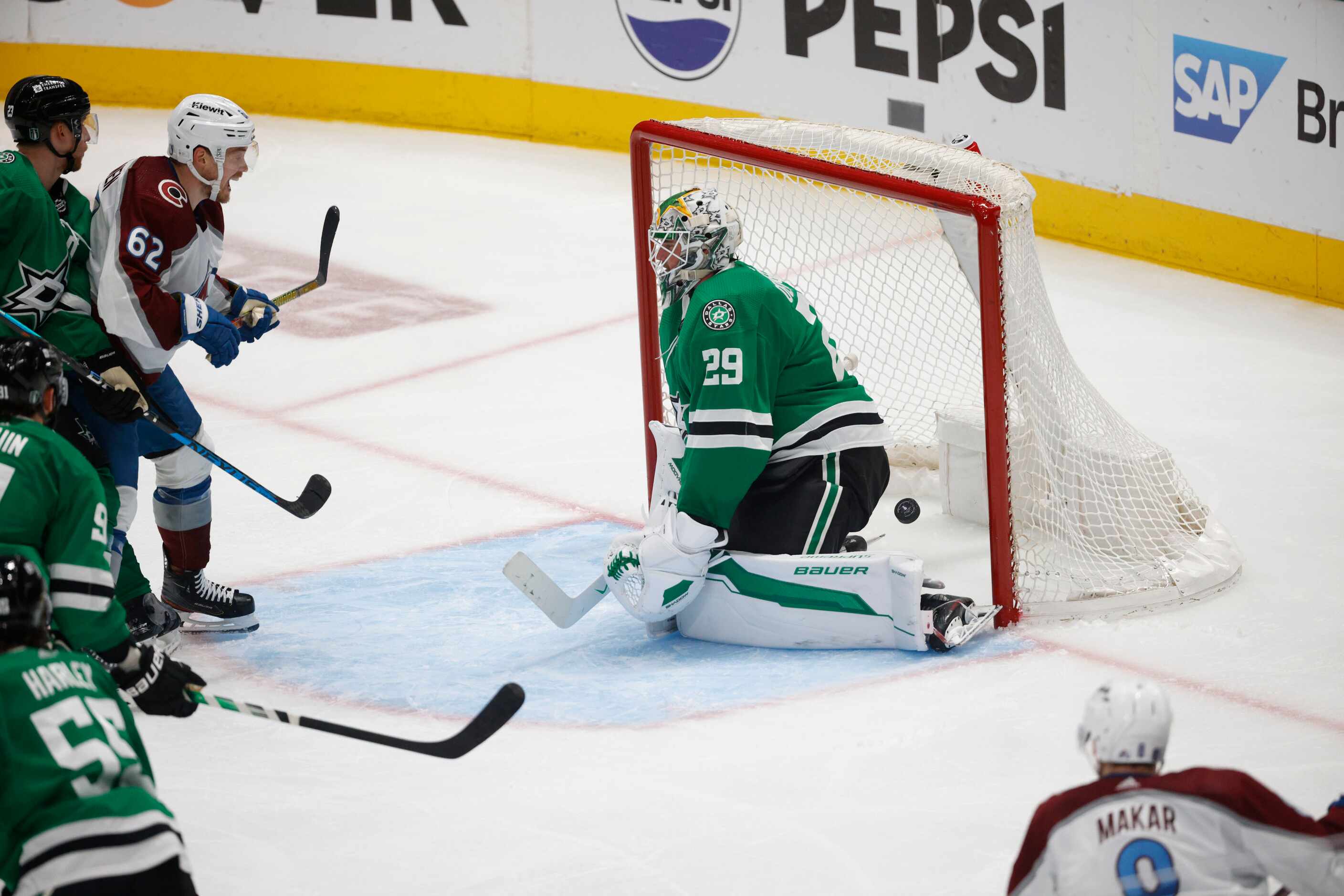 Dallas Stars goaltender Jake Oettinger (29) cannot stop a shot by Colorado Avalanche...
