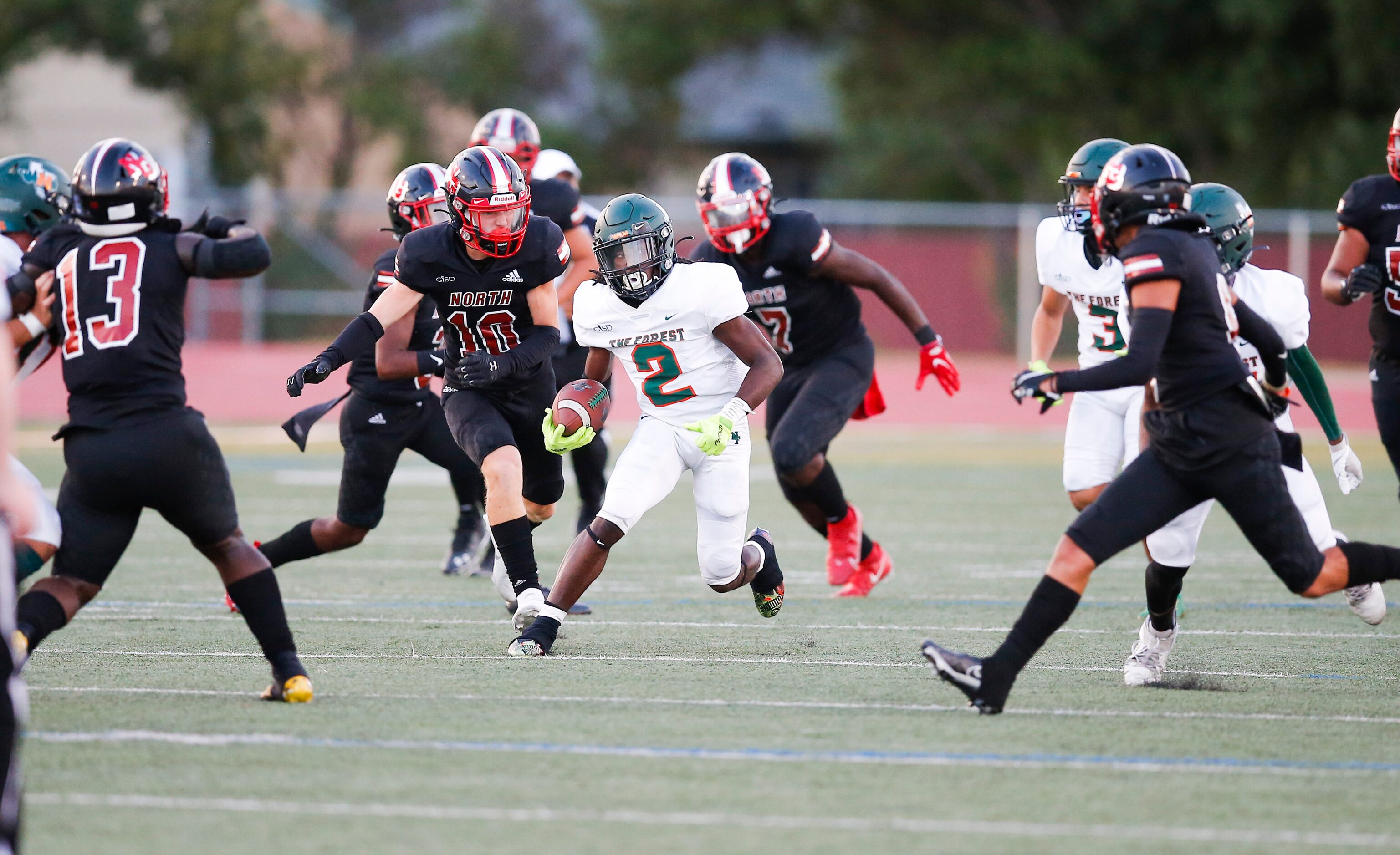 Garland Naaman Forest senior running back Kingsley Bennett (2) looks for room against the...