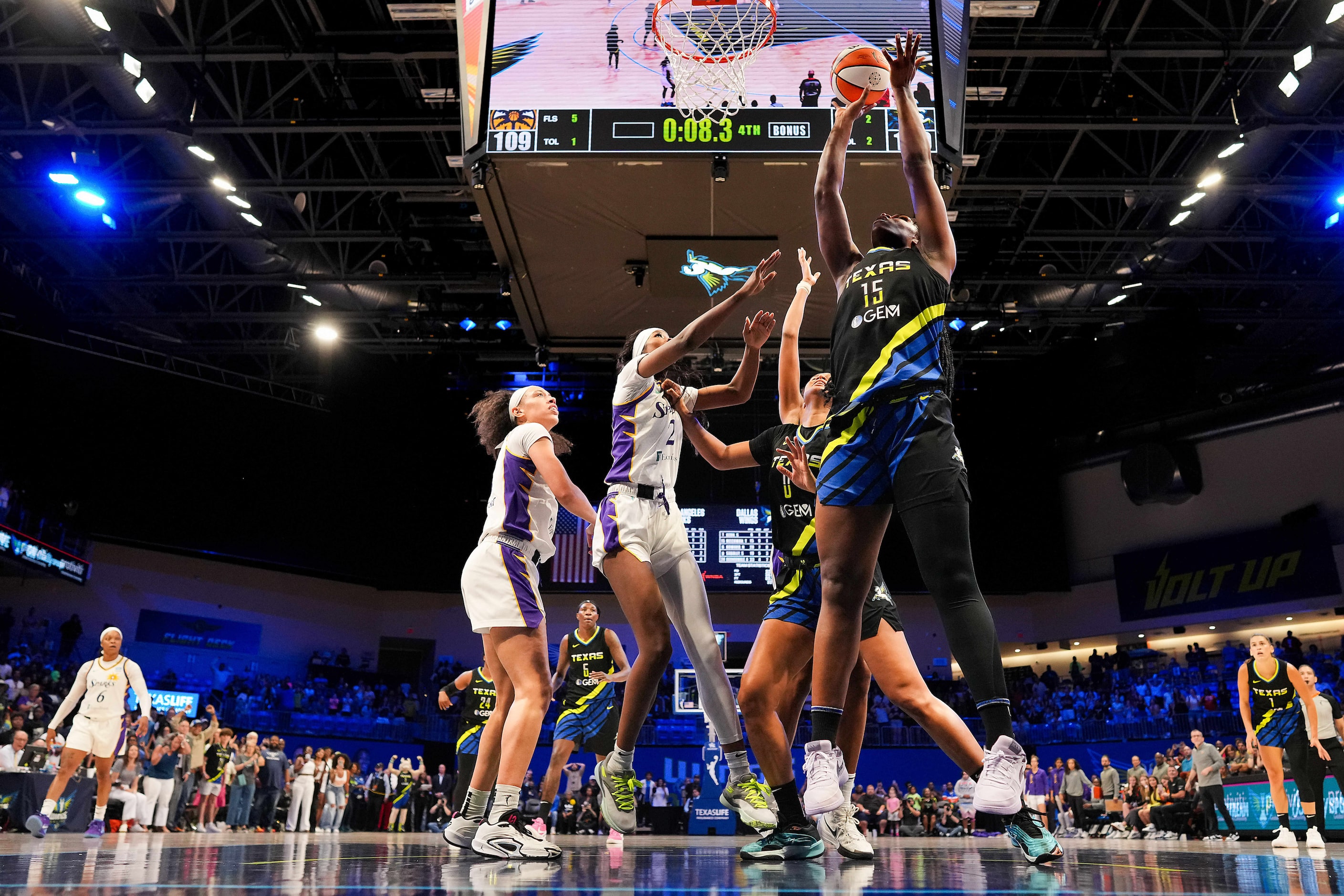 Dallas Wings center Teaira McCowan (15) goes up for a putback layup to give the Wings a...