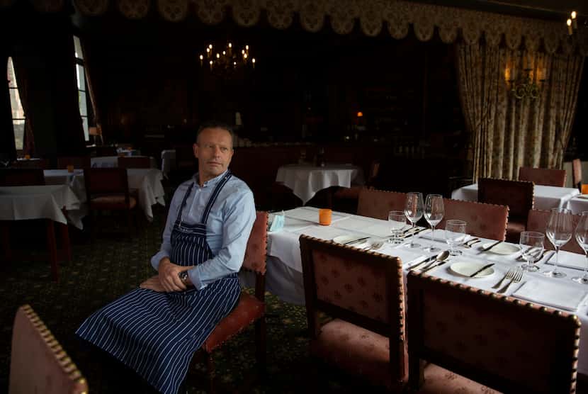 Restaurant co-owner Luc Broes sits inside his empty dining room at the Duc de Bourgogne...