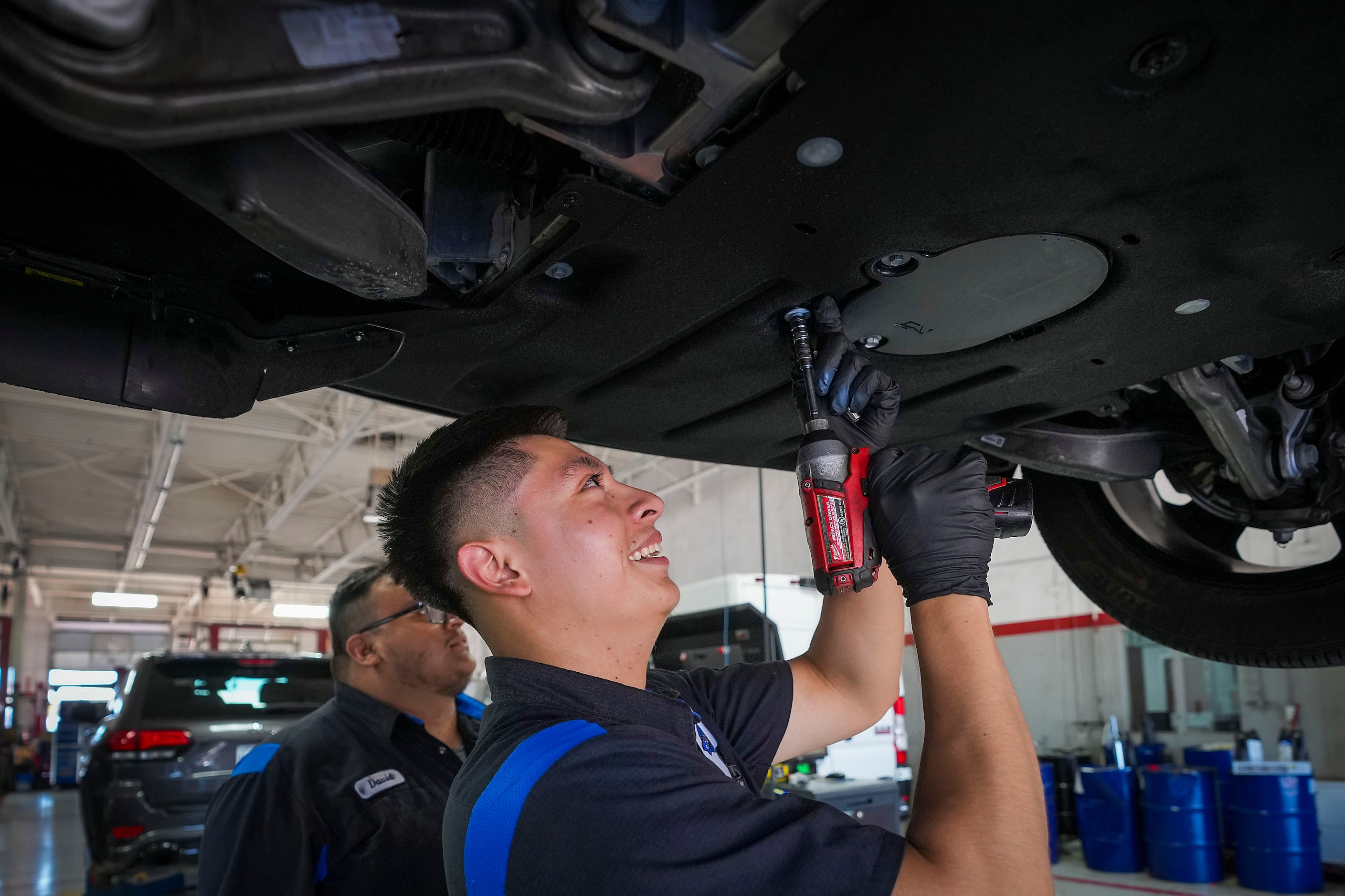 Eduardo Mojica (front) and David Campos work in the service department at Huffines Chrysler...