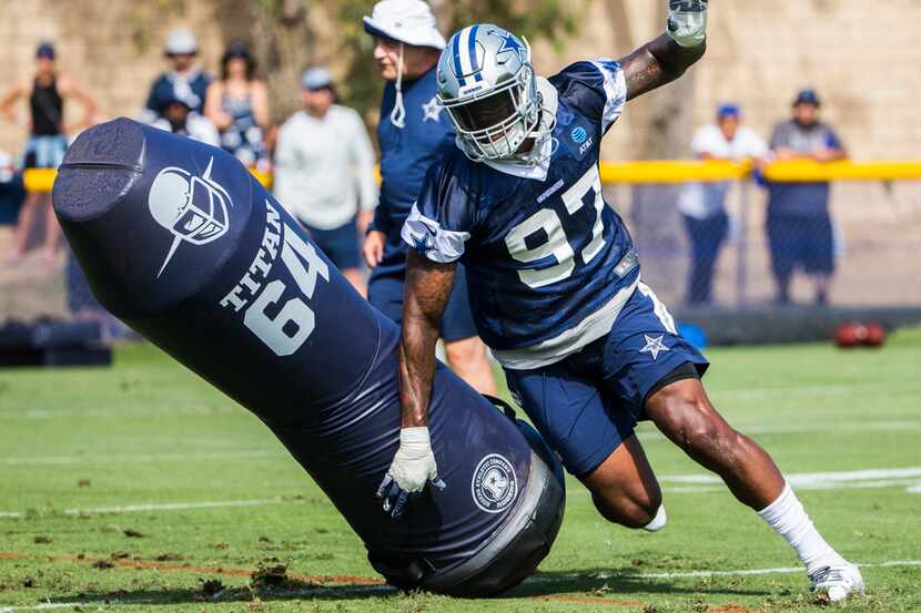 Dallas Cowboys defensive end Taco Charlton (97) runs a drill during an afternoon practice at...