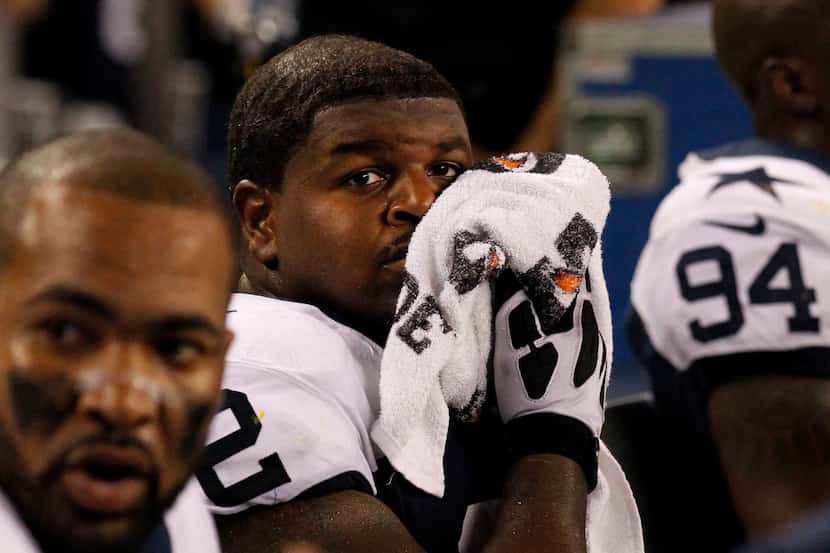 Dallas Cowboys Josh Brent, center, on the sidelines during the second half of an NFL...