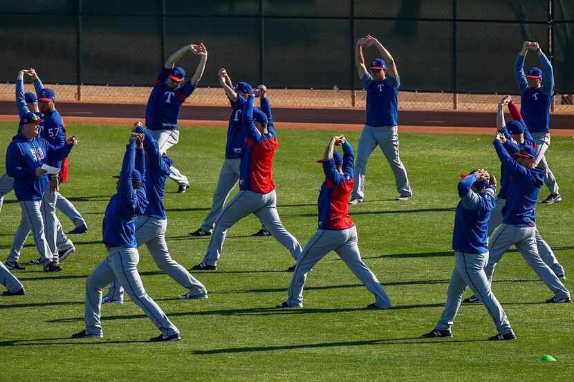 Texas Rangers player stretch during a spring training workout at the team's training...