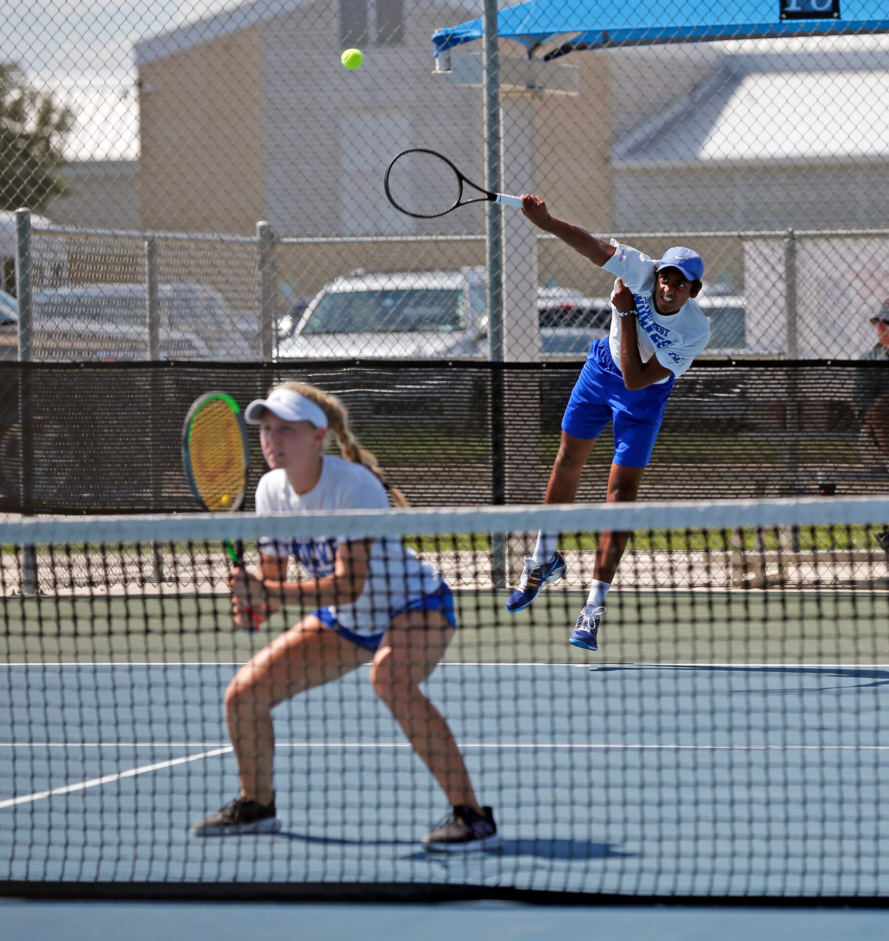 In a 6A mixed doubles match, Plano West's Summer Shannon waits as Purushotham Koduri serves....