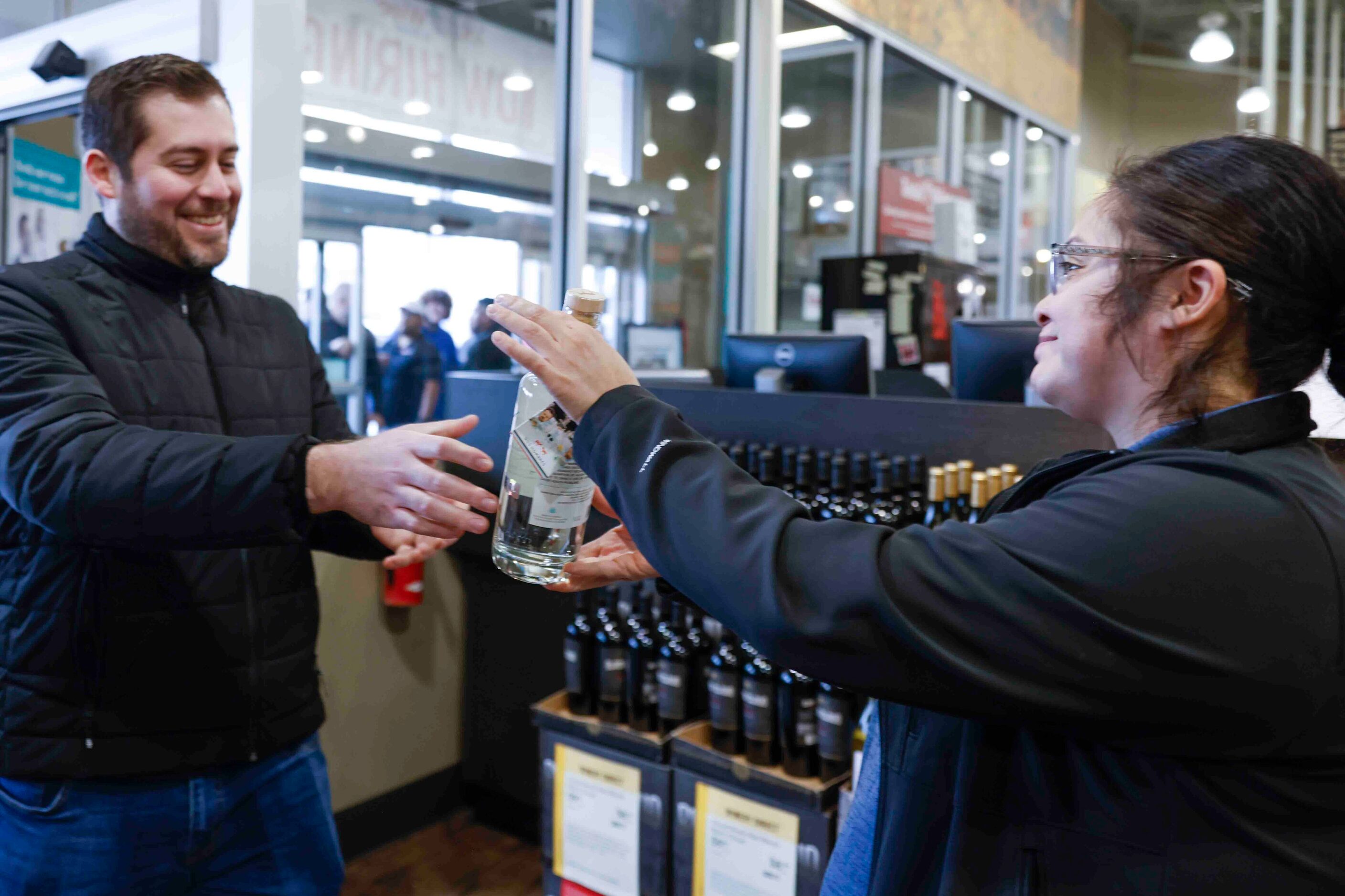 Jonathan Cerda, left, of Dallas, cheers as he receives the last Dos Hombres for the day from...