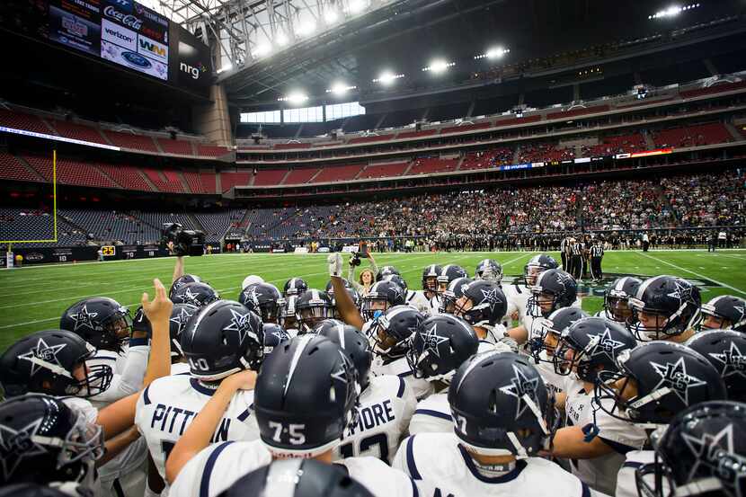 Frisco Lone Star players huddle before the Class 5A Division II state championship football...