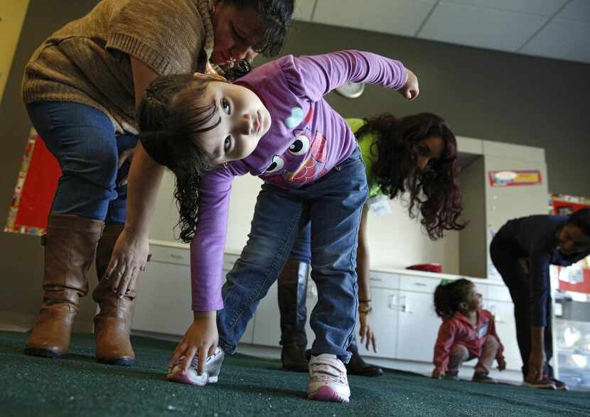 
Lesly Gonzalez, 3, stretches with her mother, Margarita Gonzalez, at the Bachman Lake...