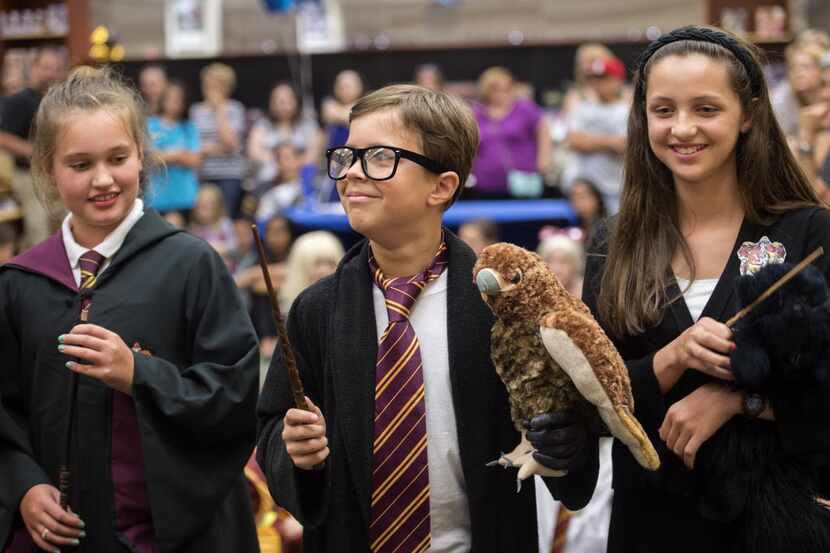 Braden Hines, 11, center, dressed as Harry Potter, awaits the announcement of his victory in...