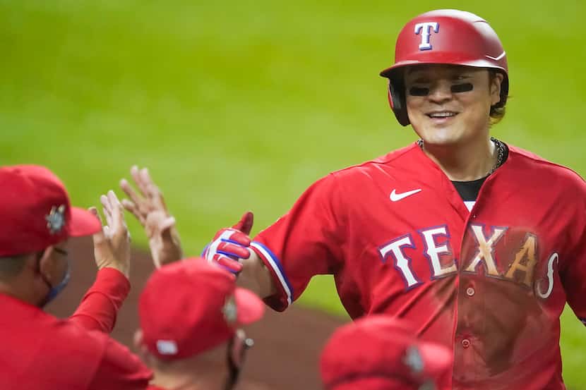 Texas Rangers designated hitter Shin-Soo Choo celebrates after scoring during the third...