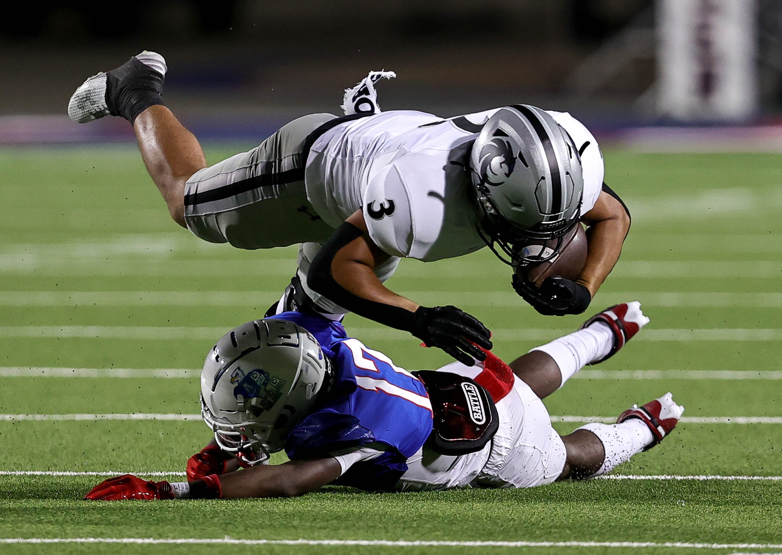 Denton Guyer running back Trey Joyner (3) gets tripped up by Allen defensive back Kai...