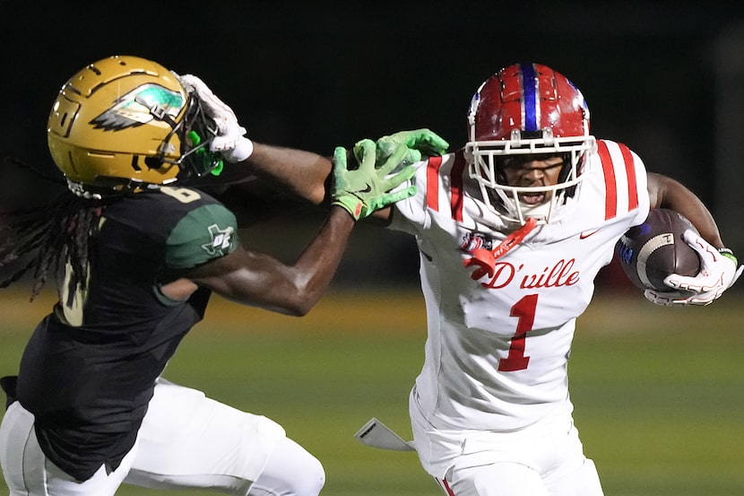 Duncanville wide receiver Dakorien Moore (1) pushes pas DeSoto defensive back Caleb Holmes...