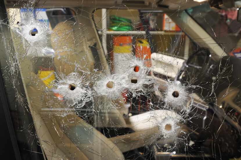 Bullet holes are seen in the passenger side of a Range Rover after Juan Jesús Guerrero...