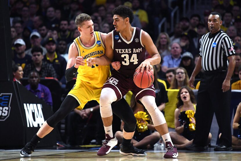 LOS ANGELES, CA - MARCH 22: Tyler Davis #34 of the Texas A&M Aggies is defended by Moritz...