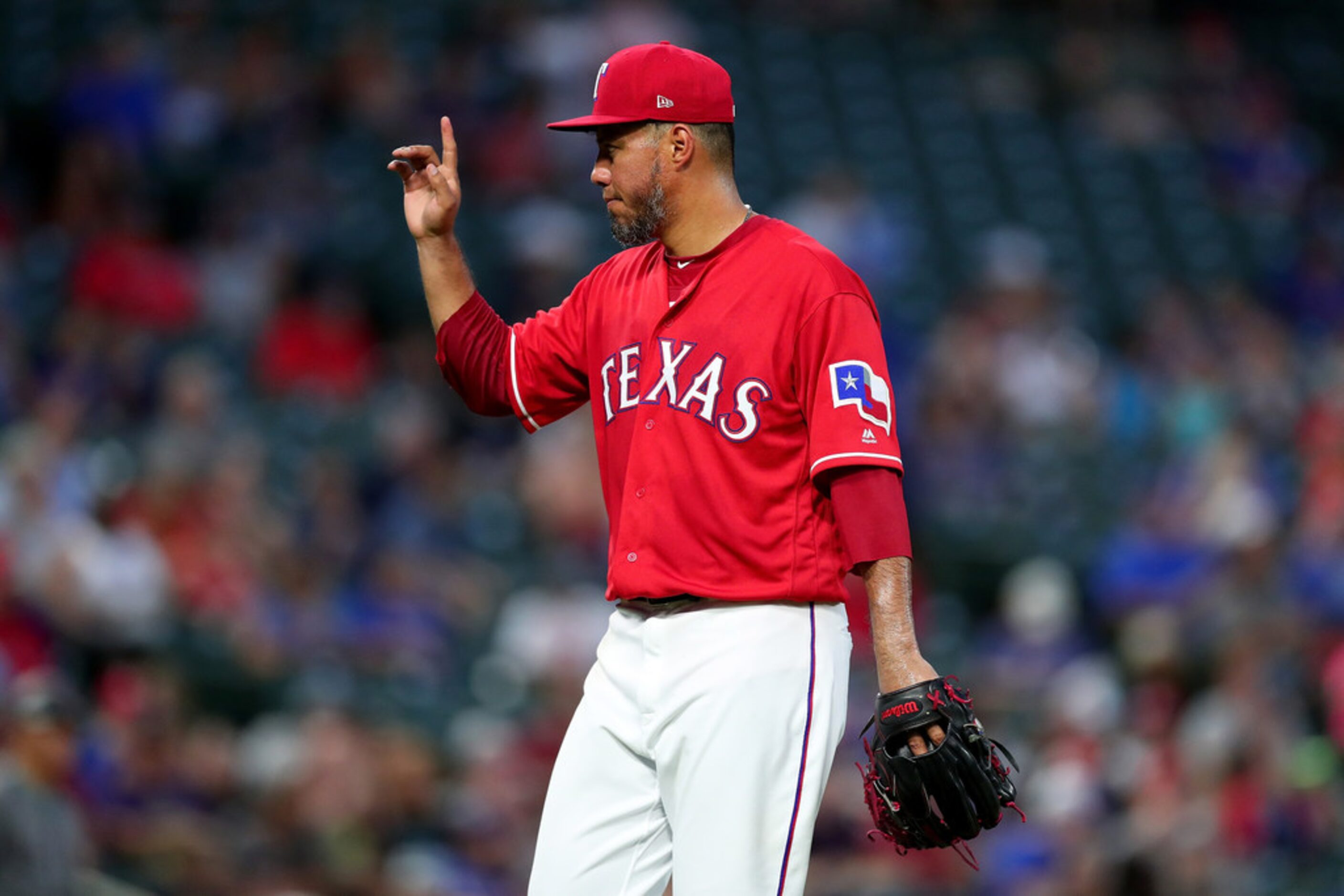 ARLINGTON, TX - AUGUST 14:  Yovani Gallardo #49 of the Texas Rangers reacts after being...