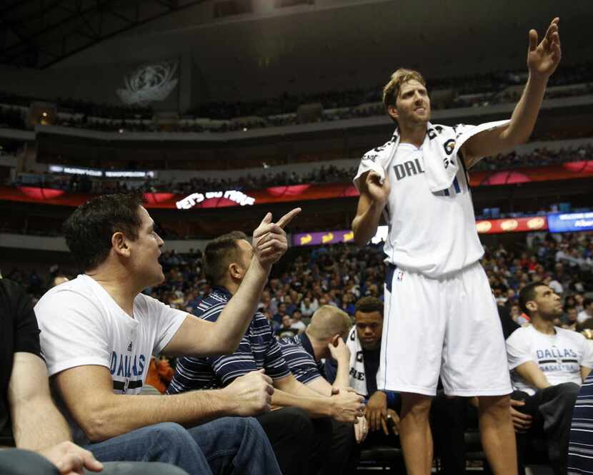 Dallas Mavericks owner Mark Cuban talks to Dallas Mavericks forward Dirk Nowitzki (41)...