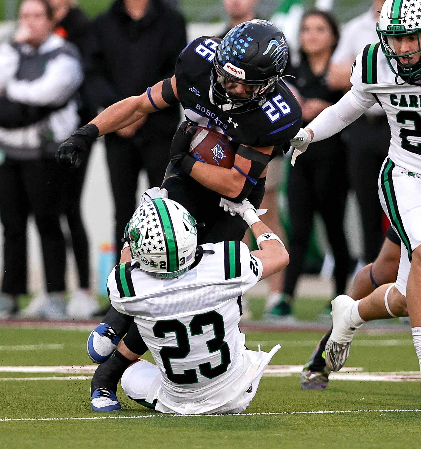 Byron Nelson running back Tucker James (26) tries to run over Southlake Carroll defensive...