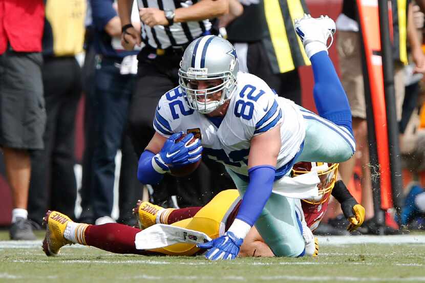 Dallas Cowboys tight end Jason Witten (82) is tackled by 
Washington Redskins inside...