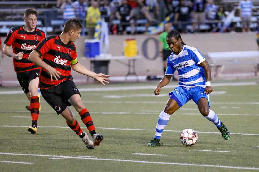 Darren Mitchell of the Fort Worth Vaqueros tries to get past Brandon Terwege of Denton...