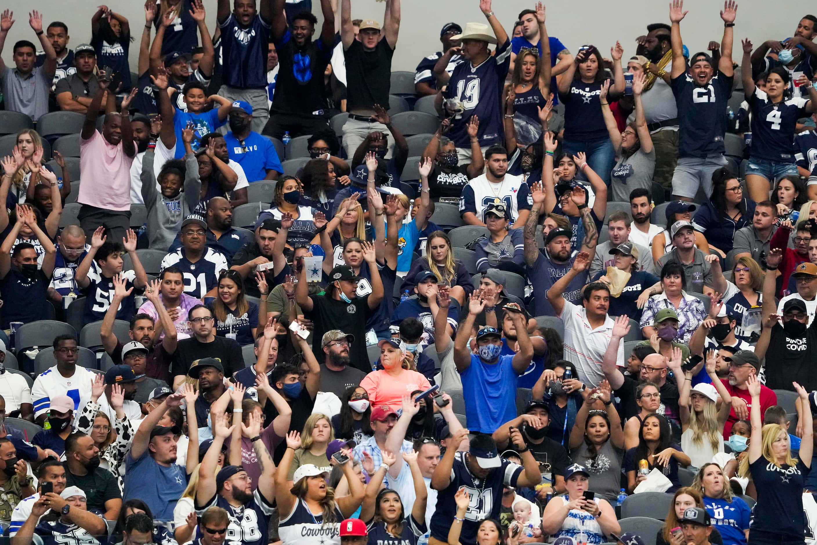 Dallas Cowboys fans do the wave during the second half of a preseason NFL football game...
