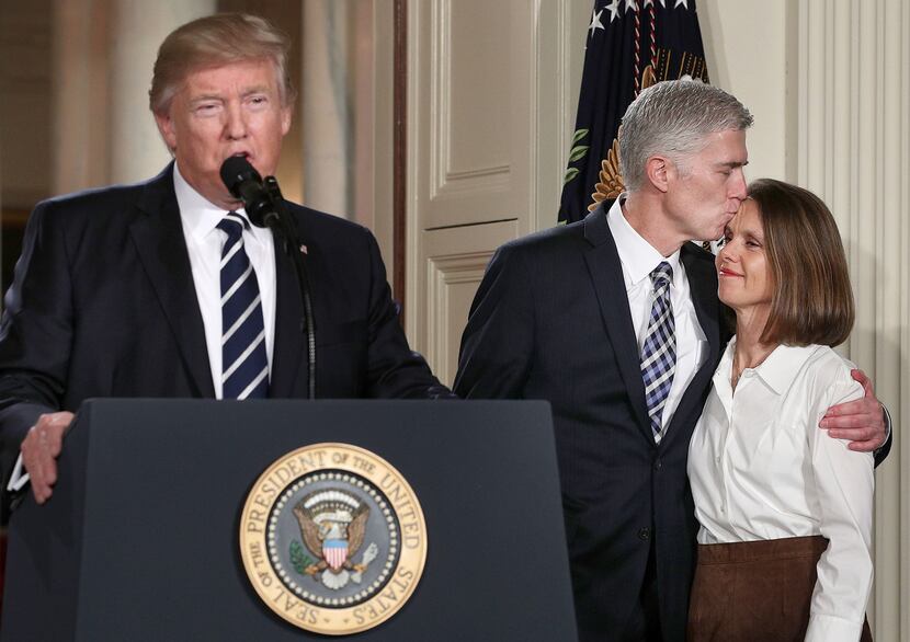 Judge Neil Gorsuch kisses his wife Louise as U.S. President Donald Trump nominates him to...