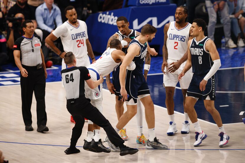 Los Angeles Clippers guard Russell Westbrook shoves Dallas Mavericks forward PJ Washington...