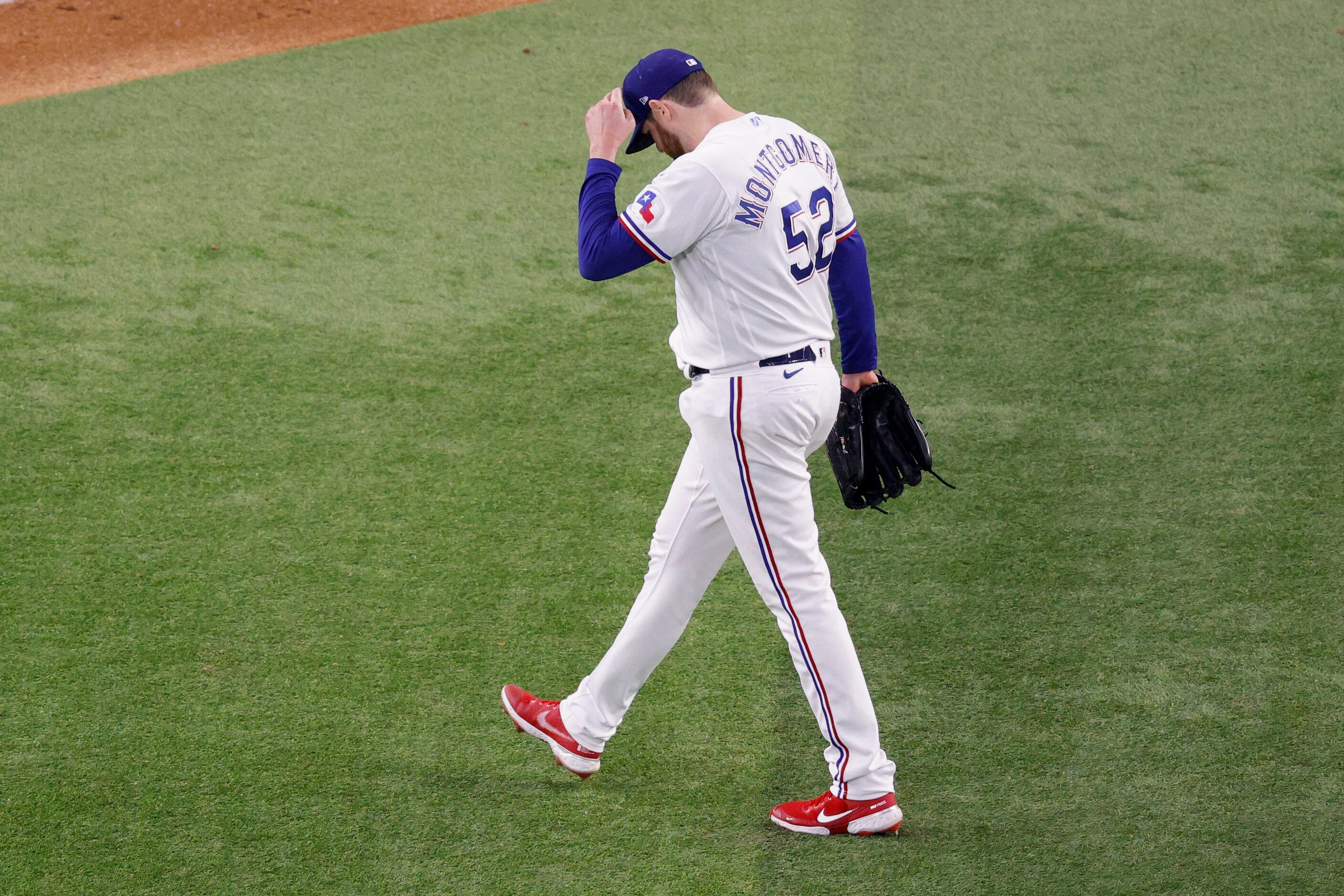 Texas Rangers starting pitcher Jordan Montgomery (52) exits the game after being replaced by...