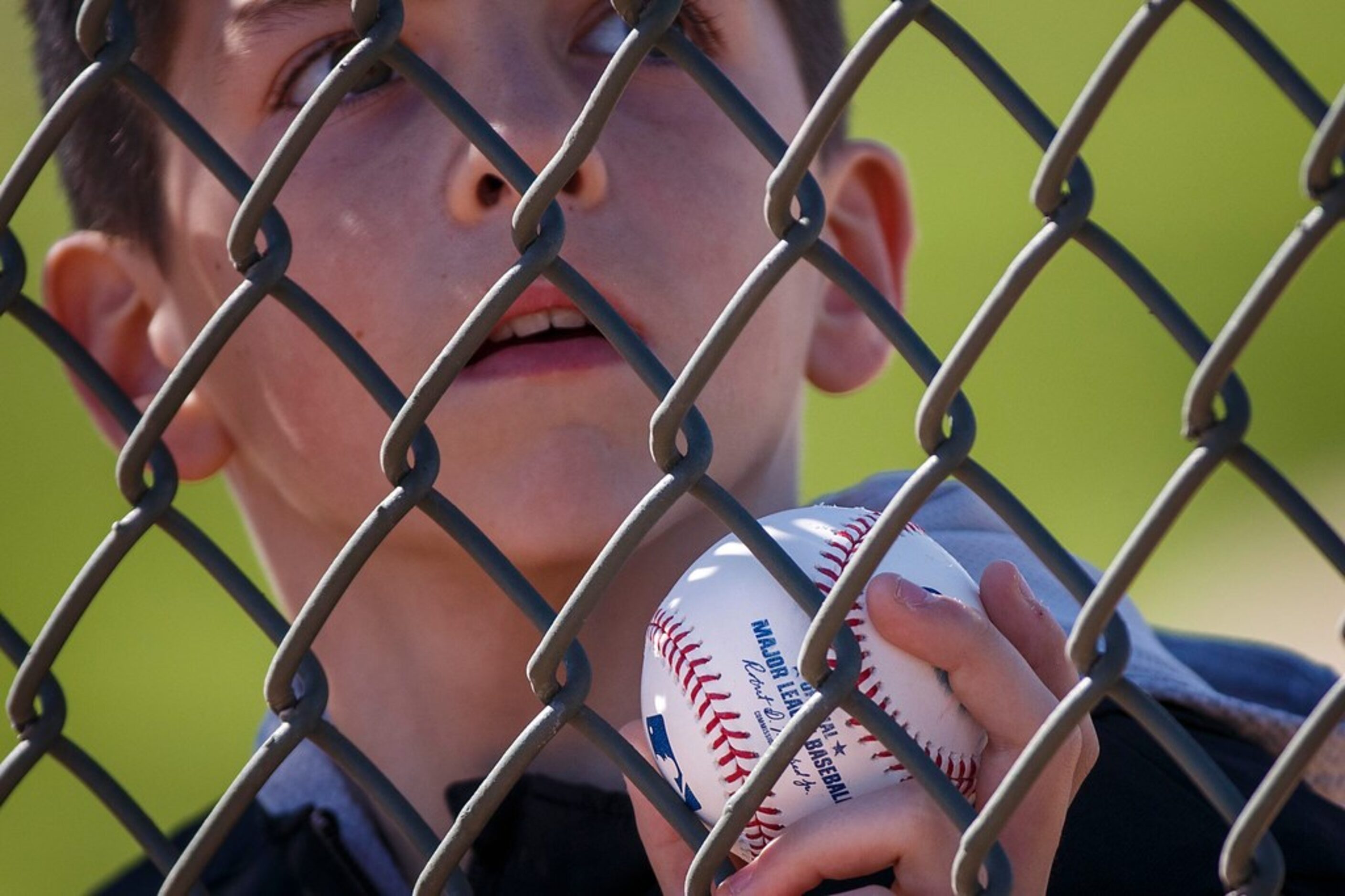 A young fan waits for autographs during a Texas Rangers spring training workout at the...