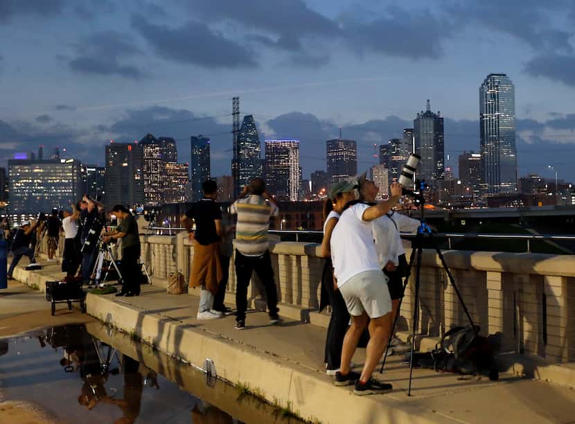As darkness falls over downtown Dallas, astro photography enthusiasts photograph the moon...