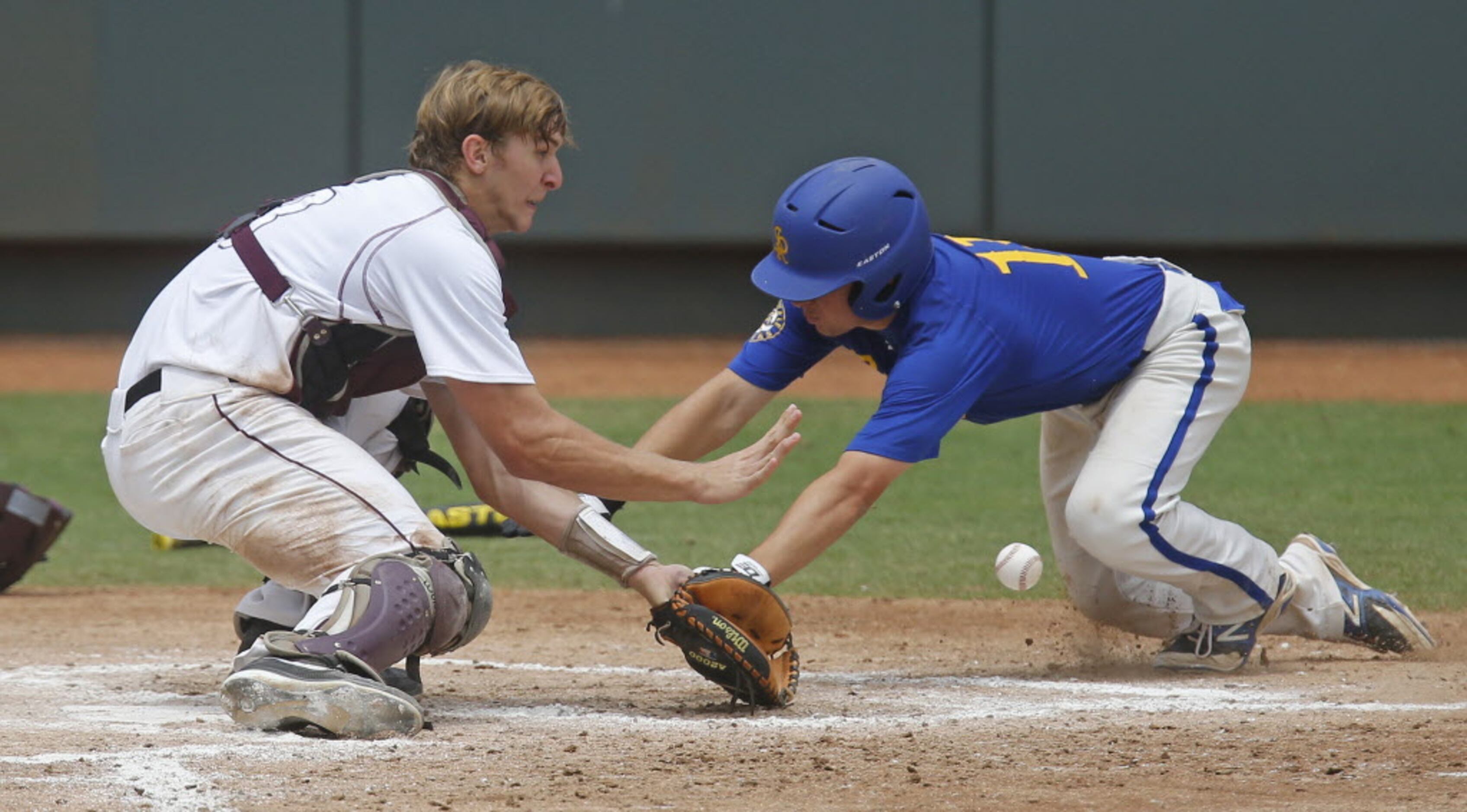 Sunnyvale's Joey Rosato (11) dives home with a third inning run as Troy catcher Kyle Whitley...