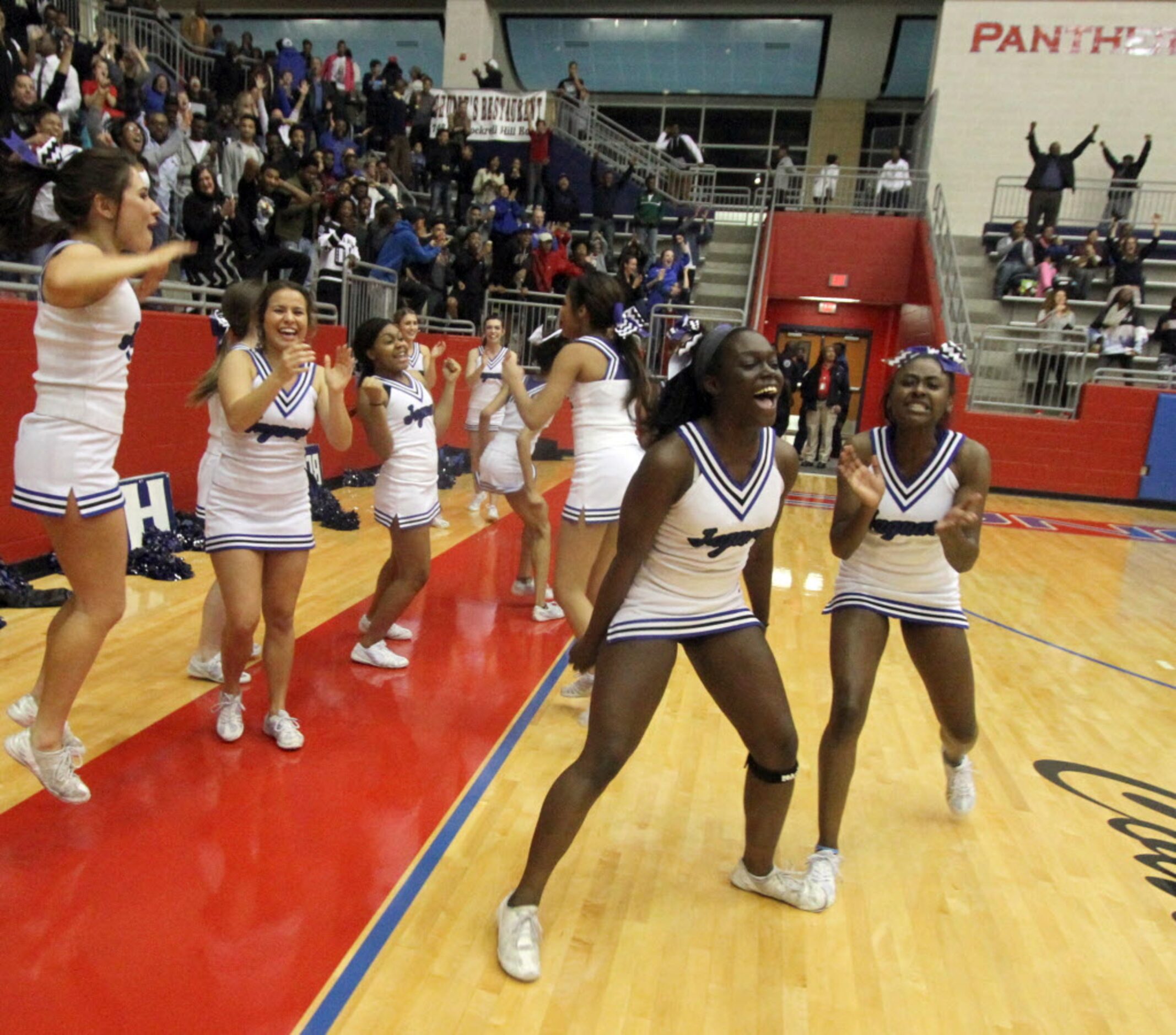 A group of Mansfield Summit cheerleaders react to a score with time running out in their...