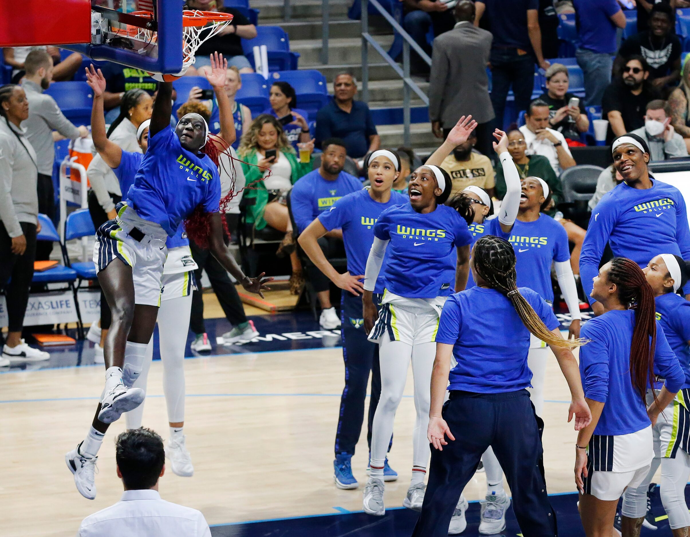 Dallas Wings center Awak Kuier (28) performs her traditional pregame dunk as her teammates...