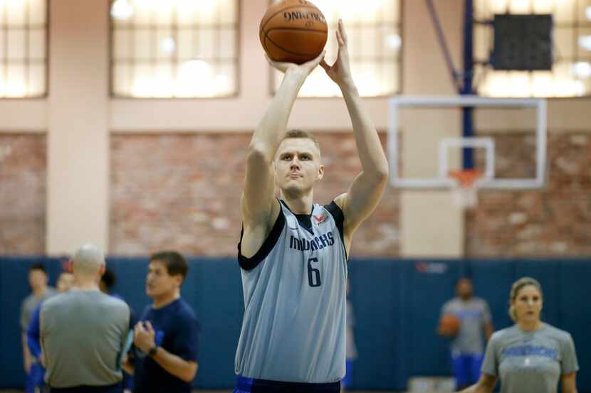 FILE - Dallas Mavericks forward Kristaps Porzingis (6) practices shooting free throws during...