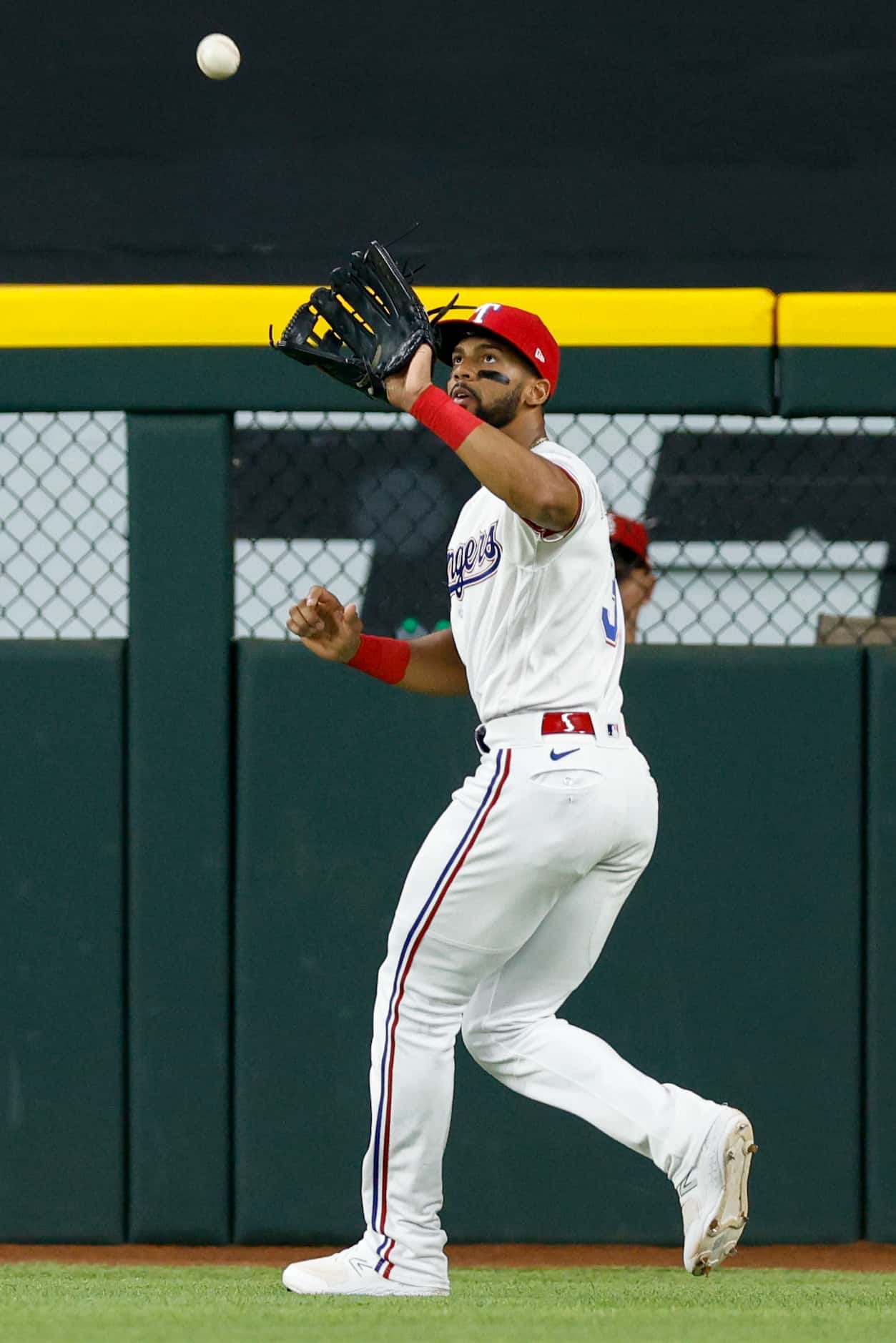 Texas Rangers center fielder Leody Taveras (3) catches a fly ball for an out in the fifth...