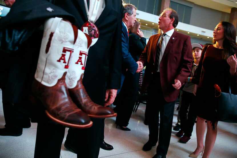 Royce Hickman with the chamber of commerce greats the new Texas A&M's coach Jimbo Fisher...