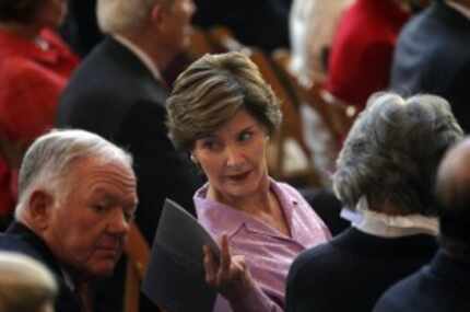  Ray L. Hunt (left), chairman of Hunt Consolidated, confers with former first lady Laura...