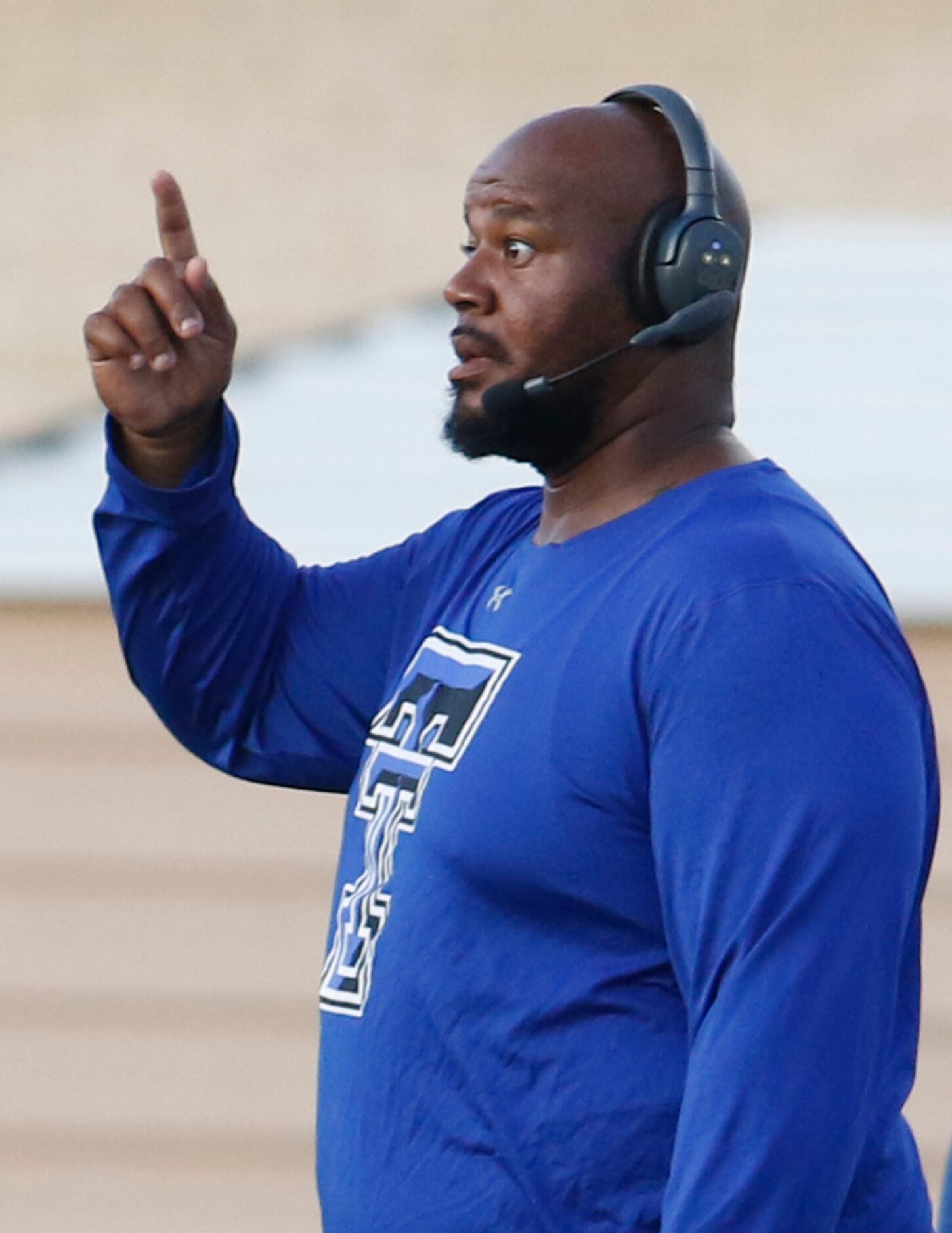 Trinity Christian-Cedar Hill head coach Andre Hart directs his players from the team...