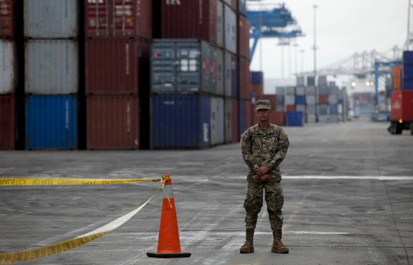 A police officer stands guard at the Manzanillo International container terminal where the...
