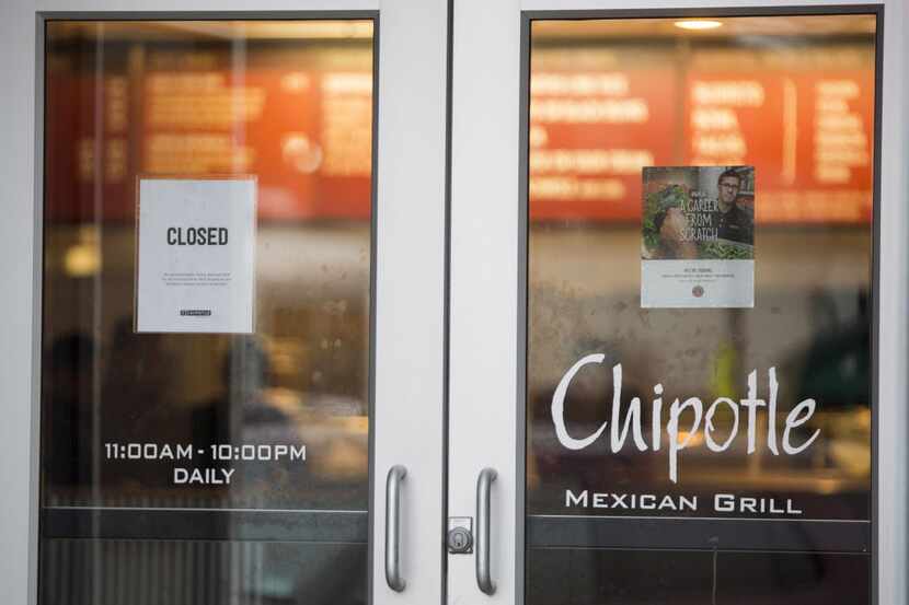 A sign showing that the Chipotle Mexican Grill seen at 1924 Beacon St. is closed on December...