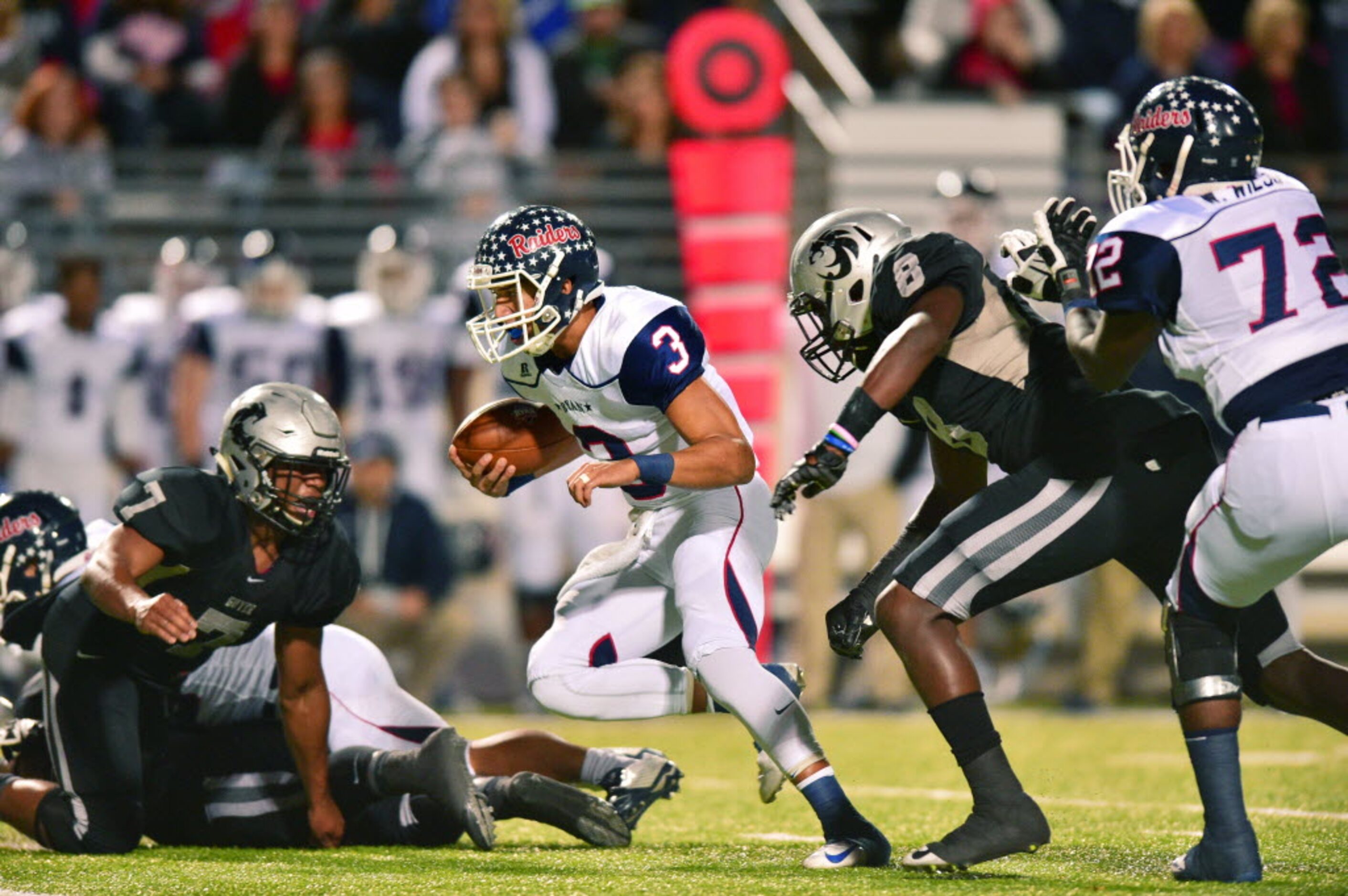 Ryan sophomore quarterback Spencer Sanders (3) finds room to run up the middle against...